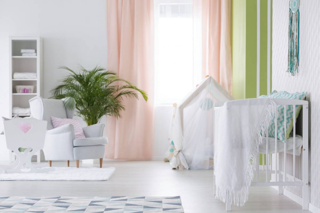White modest interior of baby room with cradle